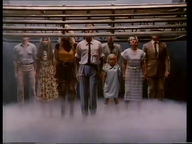 Still from the 1987 Grim Reaper campaign: a line of men, women and children standing as bowling pins under the pin-setter of a fog-filled lane.