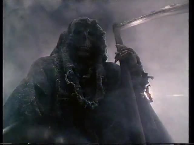 Still from the 1987 Grim Reaper campaign: the hooded skeleton at the head of the lane, a bowling ball in one hand and a scythe in the other.
